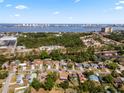 An aerial view captures a suburban neighborhood near a waterfront city skyline, with easy access to parking at 2524 Anastasia Dr, South Daytona, FL 32119