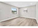 Bright bedroom with new flooring, fresh paint and natural light from large window at 2524 Anastasia Dr, South Daytona, FL 32119
