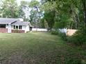 Spacious backyard featuring a well-maintained lawn and perimeter fence, perfect for outdoor activities at 26225 Troon Ave, Mount Plymouth, FL 32776