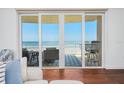 Ocean view from sliding glass doors leading to balcony, with seating and blue rug at 2855 S Atlantic Ave # 303, Daytona Beach Shores, FL 32118