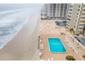Aerial view showcasing the complex's beachfront location, pool, and proximity to the ocean at 2947 S Atlantic Ave # 201, Daytona Beach Shores, FL 32118