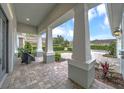 Covered front porch with tiled flooring and stylish seating, offering a comfortable outdoor living space at 302 Lamberton Ln, Deland, FL 32724