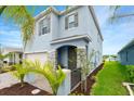 Charming entrance to a two-story home with stone accents and lush landscaping at 3120 Areca Ave, New Smyrna Beach, FL 32168