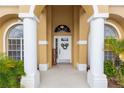 Inviting front porch with decorative wreath and supporting columns, creating a welcoming entrance at 316 Oak Springs Dr, Debary, FL 32713