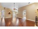 Spacious living area featuring hardwood floors, a decorative fountain, and arched doorways leading to other rooms at 3267 Wild Pepper Ct, Deltona, FL 32725