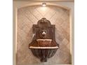 Close-up shot of a unique lion head fountain with decorative tile in a cozy living area at 3267 Wild Pepper Ct, Deltona, FL 32725