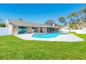 Serene backyard features a sparkling pool, perfect for outdoor entertaining with an enclosed lanai and lush lawn at 4745 Dixie Dr, Ponce Inlet, FL 32127