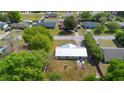 Aerial view of the home with a new silver metal roof, spacious backyard, mature trees, and fire pit at 4836 Ne 26Th Ter, Ocala, FL 34479