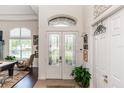 Elegant foyer featuring tile flooring and double glass doors at 4901 Lake Milly Dr, Orlando, FL 32839