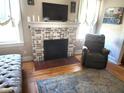 Living Room featuring fireplace, wood floors, large area rug and furniture at 503 5Th Ave, Daytona Beach, FL 32118
