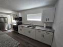 Renovated kitchen featuring stainless appliances and granite countertops at 508 N Keech St, Daytona Beach, FL 32114