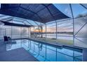 Screened pool area with a gorgeous view of the lake, perfect for relaxation and enjoyment at 5298 Bear Corn Run, Port Orange, FL 32128
