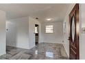 Living room features an open layout, tile floors, neutral paint, and natural light through multiple windows at 600 Holmes Ave, Daytona Beach, FL 32114