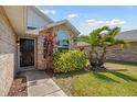 A welcoming entrance to a single Gathering home surrounded by lush landscaping and a brick exterior at 914 Smokerise Blvd, Port Orange, FL 32127