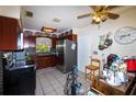 Functional kitchen with stainless steel appliances, ample cabinet space, and a ceiling fan for added comfort at 950 Windway Cir, Kissimmee, FL 34744