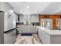 Spacious kitchen with stainless steel appliances, gray cabinets, and wood-look tile flooring at 1560 S Pearl St, Deland, FL 32720