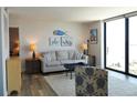 Cozy living room features water views from the large window and coastal decor at 1 Oceans West Blvd # 20B4, Daytona Beach, FL 32118