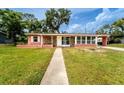 Charming home with a manicured lawn, freshly painted exterior, and a welcoming front porch at 1160 Fountainhead Dr, Deltona, FL 32725