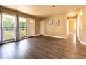 Open living room with wood floors, large windows, and neutral walls at 1160 Fountainhead Dr, Deltona, FL 32725