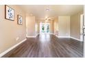 Bright living room with wood floors and glass doors that lead to a lush outdoor space at 1160 Fountainhead Dr, Deltona, FL 32725