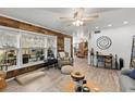 Inviting living room with a cozy armchair, wood floors, a decorative wood wall, and lots of natural light at 135 Moonstone Ct, Port Orange, FL 32129