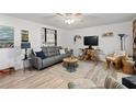 Comfortable living room featuring a plush gray sofa, unique wood accents, and stylish decor at 135 Moonstone Ct, Port Orange, FL 32129