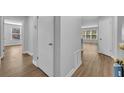 Bright hallway with laminate floors and multiple doorways at 1401 S Palmetto Ave # 300, Daytona Beach, FL 32114