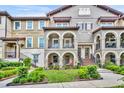 Multi-Gathering home featuring arches and red tile roof, set amid lush landscaping and a serene neighborhood at 1436 Lobelia Dr, Lake Mary, FL 32746