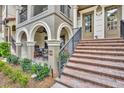 Close up exterior shot of a multi-Gathering home with brick steps leading to an arched, column-supported porch at 1436 Lobelia Dr, Lake Mary, FL 32746