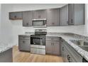 Modern kitchen featuring stainless steel appliances, granite countertops, and ample cabinet space at 1450 Benham Ave, Orange City, FL 32763