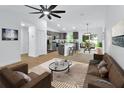 Open-concept living space featuring wood-look floors, stylish furnishings, and ample natural light at 1450 Benham Ave, Orange City, FL 32763