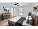 Bright bedroom with a ceiling fan, window views, and modern furnishings at 1450 Benham Ave, Orange City, FL 32763