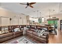 Spacious living area with hardwood floors, a comfortable sectional sofa, and an open view into the kitchen and dining area at 1550 11Th Ave, Deland, FL 32724
