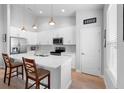 Modern kitchen featuring white cabinets, a large island, stainless steel appliances, and sleek countertops at 1601 Toledo Ave, Deltona, FL 32725