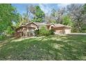 Lovely single-story brick home nestled amongst mature trees, offering shade and privacy at 1925 Hamilton Ave, Orange City, FL 32763