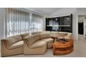 Spacious living room featuring a unique sectional sofa, modern shelving unit, and bright natural light at 1925 Hamilton Ave, Orange City, FL 32763