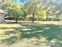 Expansive backyard with lush green grass and mature trees creating a serene outdoor space at 2053 Bond Rd, Deland, FL 32720