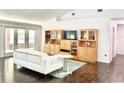 Bright living room with hardwood floors, vaulted ceilings, and stylish built-in shelving at 2053 Bond Rd, Deland, FL 32720