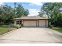 Spacious two car garage and driveway provide ample parking at 229 Riverbend Rd, Ormond Beach, FL 32174