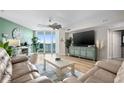 Open living room with light wood floors, comfortable seating, and scenic waterfront views at 241 Riverside Dr # 304, Daytona Beach, FL 32117