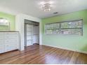 Bright bedroom with wood floors and an organized closet at 243 S Hull Ave, Deland, FL 32720