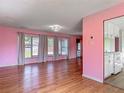 Bright living room with hardwood floors, and large windows offering plentiful natural light at 243 S Hull Ave, Deland, FL 32720
