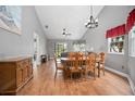 Cozy dining room with wooden table and chairs set on hardwood floors at 2596 Lancaster Ct, Apopka, FL 32703