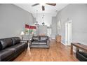 Bright open-concept living room featuring vaulted ceilings and hardwood floors at 2596 Lancaster Ct, Apopka, FL 32703