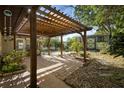 Inviting outdoor patio featuring a wooden pergola, brick flooring, and lush greenery at 265 S Fairbairn Dr, Deltona, FL 32725