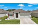 Inviting single-story home featuring a two-car garage, landscaped front yard, and a cozy, neutral color scheme at 2686 Neverland Dr, New Smyrna Beach, FL 32168