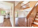 Open-concept living space with hardwood floors, vaulted ceilings, and a staircase leading to the upper level at 2819 Silver Palm Dr, Edgewater, FL 32141