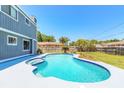 Backyard featuring a sparkling swimming pool with an attached spa and a spacious patio area for entertaining guests at 2819 Silver Palm Dr, Edgewater, FL 32141