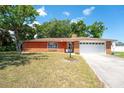 Charming brick home with a manicured lawn and mature trees in a quiet neighborhood at 291 Sagewood Dr, Port Orange, FL 32127