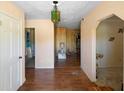 View of the front hallway featuring laminate wood floors, a decorative chandelier, and peach painted walls at 2919 Griffin Rd, Leesburg, FL 34748